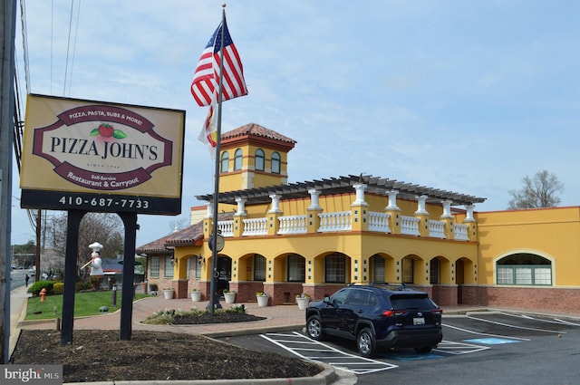view of building exterior featuring uncovered parking