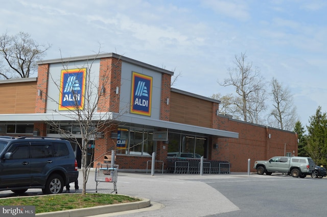 view of building exterior featuring uncovered parking