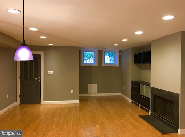 basement with recessed lighting, baseboards, and light wood finished floors