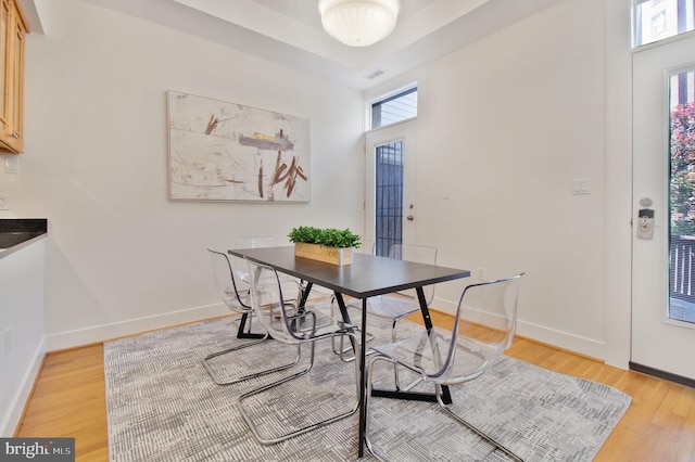 dining room featuring baseboards and light wood finished floors