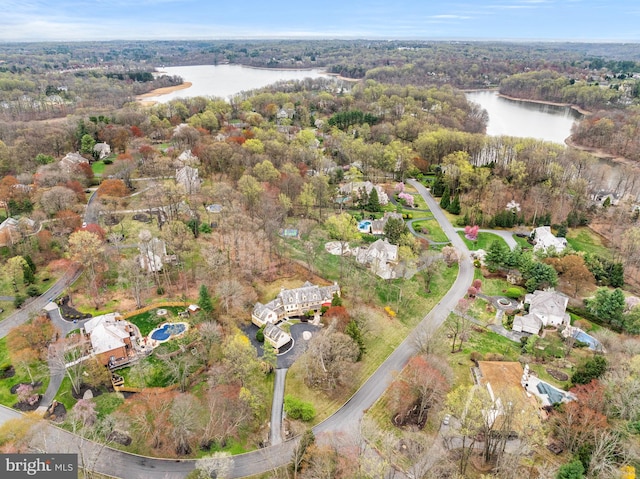 aerial view featuring a water view and a wooded view