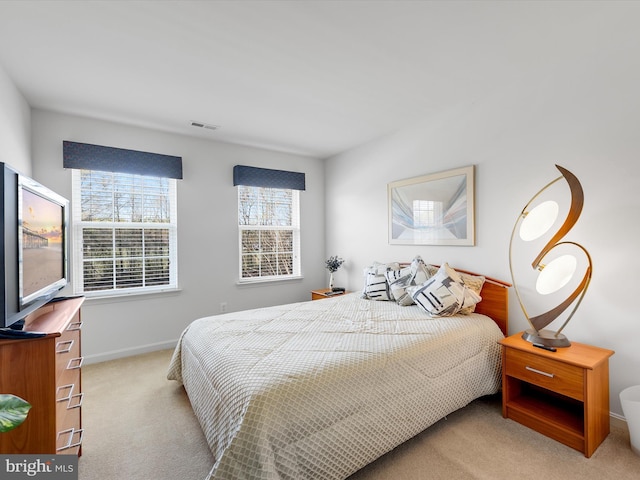 carpeted bedroom featuring baseboards and visible vents