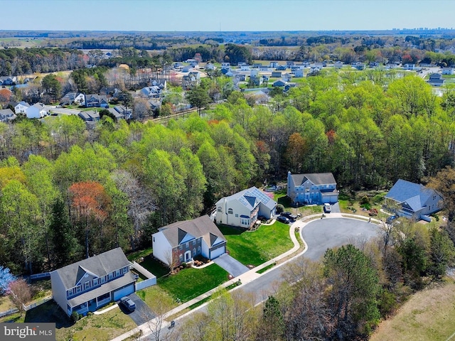bird's eye view featuring a forest view and a residential view