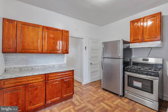 kitchen with brown cabinetry, appliances with stainless steel finishes, backsplash, and under cabinet range hood