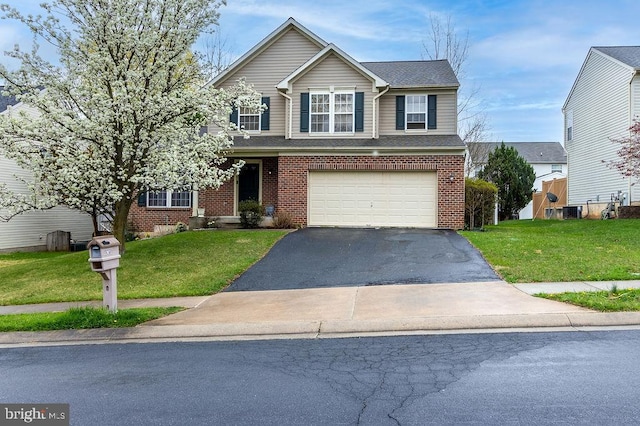 traditional-style house featuring a front yard, an attached garage, brick siding, and driveway