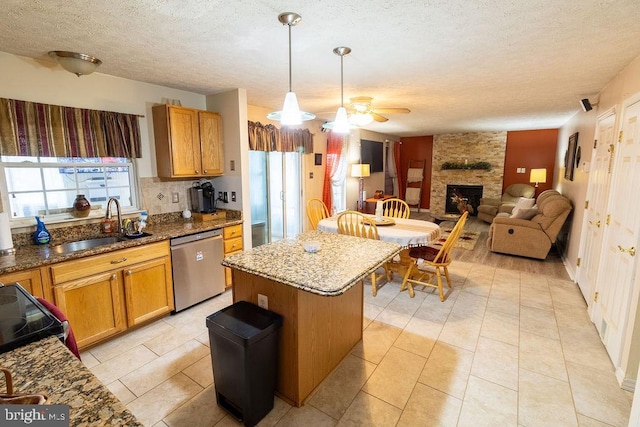 kitchen featuring stainless steel dishwasher, a fireplace, stone counters, a ceiling fan, and black electric range