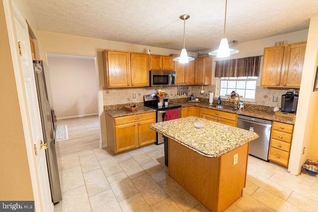 kitchen featuring a sink, a center island, tasteful backsplash, and stainless steel appliances