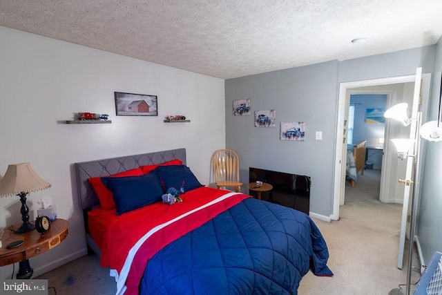 bedroom with light carpet, baseboards, and a textured ceiling