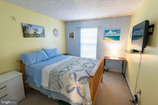 bedroom with carpet floors, baseboards, and a textured ceiling