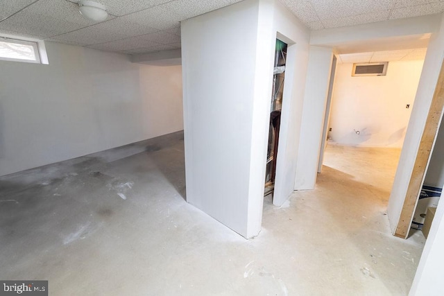 finished basement with a paneled ceiling