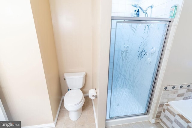 bathroom featuring baseboards, tile patterned flooring, toilet, a shower stall, and a bath