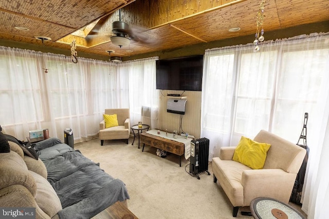 living room featuring wood ceiling, carpet flooring, and a ceiling fan