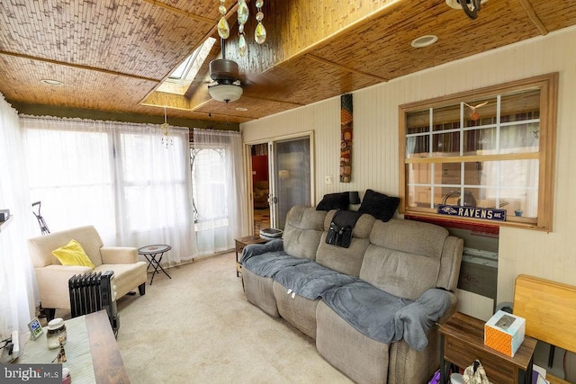 living area featuring carpet flooring and wood ceiling