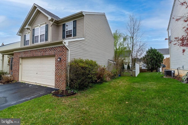 view of property exterior featuring driveway, cooling unit, an attached garage, brick siding, and a yard