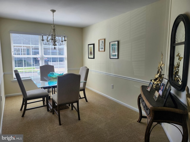 dining space with an inviting chandelier, carpet flooring, and baseboards