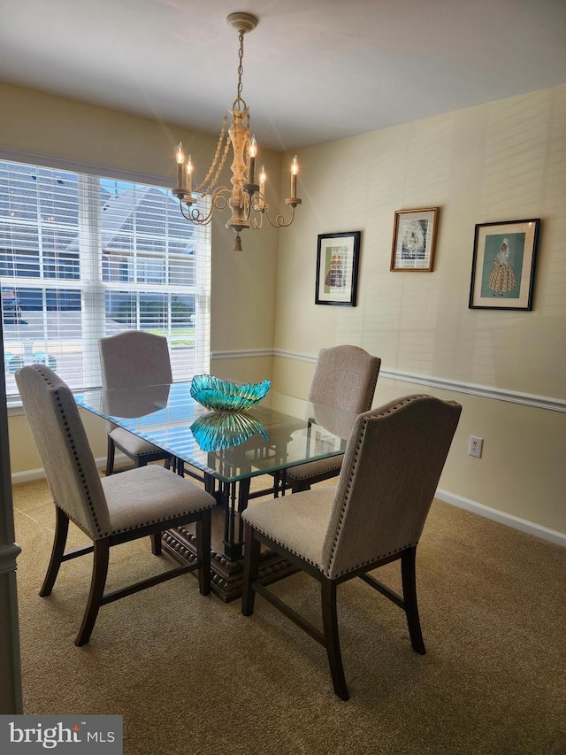 dining room with baseboards, a notable chandelier, and light carpet