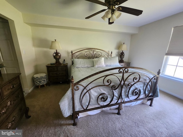 bedroom featuring baseboards, a ceiling fan, and carpet