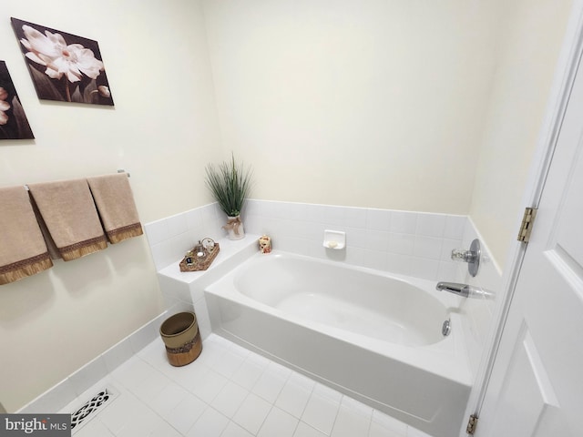 bathroom featuring tile patterned floors and a bath