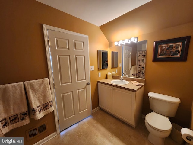 bathroom featuring toilet, vanity, baseboards, and visible vents