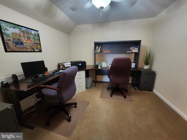 office space with light colored carpet, baseboards, and vaulted ceiling