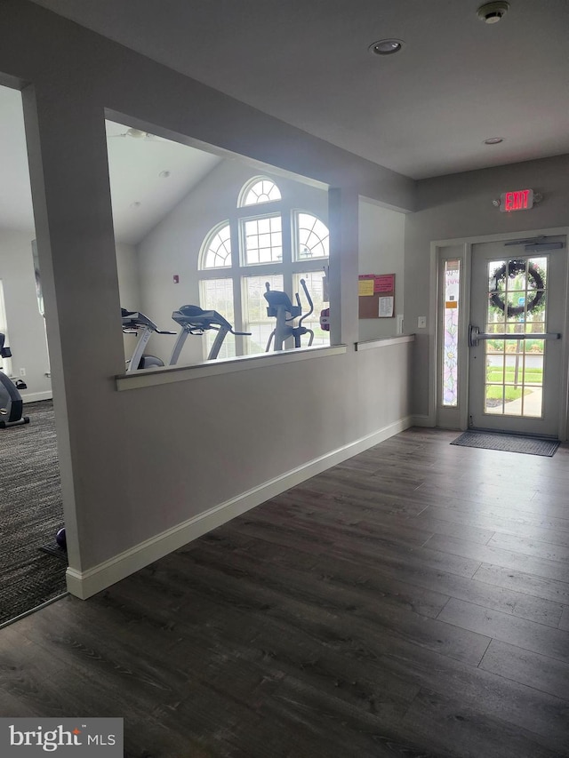 entryway with baseboards, plenty of natural light, and wood finished floors