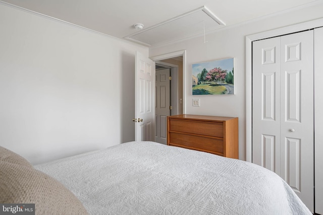 bedroom featuring attic access and a closet