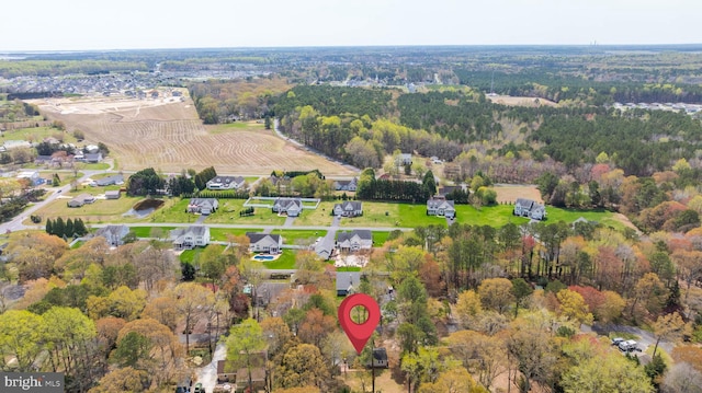 drone / aerial view with a wooded view