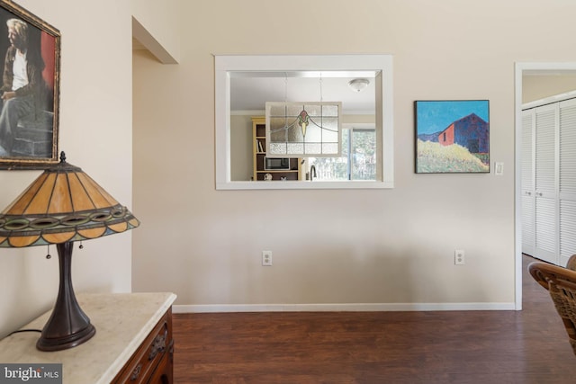 interior space with dark wood-style flooring and baseboards