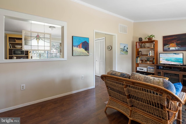 living area with baseboards, ornamental molding, dark wood finished floors, and visible vents