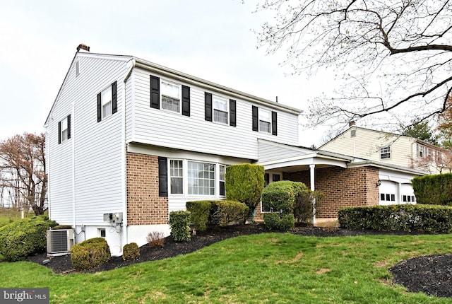 745 Champlain Dr, King Of Prussia, PA 19406 - colonial inspired home with central air condition unit, a chimney, an attached garage, a front lawn, and brick siding