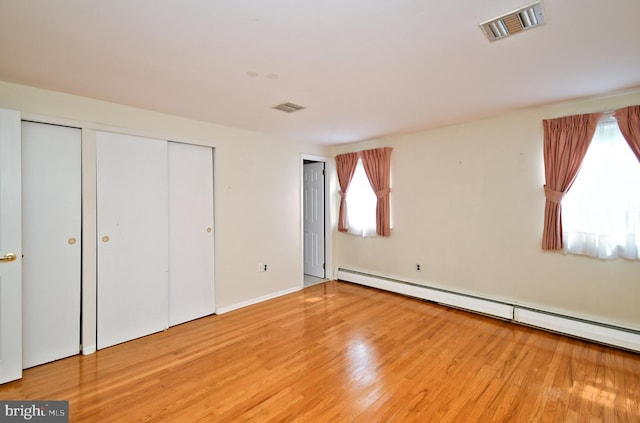 745 Champlain Dr, King Of Prussia, PA 19406 - unfurnished bedroom with baseboard heating, wood finished floors, a closet, and visible vents
