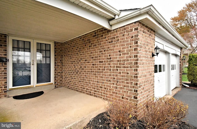 745 Champlain Dr, King Of Prussia, PA 19406 - view of exterior entry with brick siding, french doors, an attached garage, and driveway