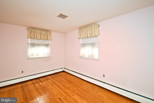 745 Champlain Dr, King Of Prussia, PA 19406 - unfurnished room featuring light wood finished floors, a healthy amount of sunlight, a baseboard heating unit, and visible vents