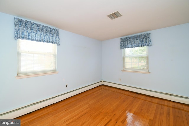 745 Champlain Dr, King Of Prussia, PA 19406 - spare room featuring baseboard heating, visible vents, and hardwood / wood-style floors