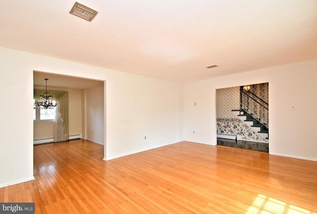 745 Champlain Dr, King Of Prussia, PA 19406 - unfurnished living room featuring a chandelier, stairway, visible vents, and light wood finished floors