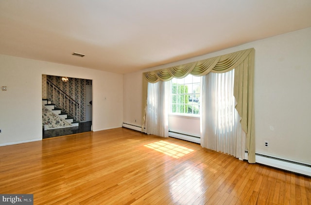 745 Champlain Dr, King Of Prussia, PA 19406 - unfurnished room with stairs, wood-type flooring, visible vents, and a baseboard heating unit