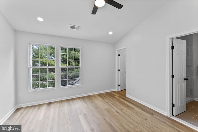 unfurnished bedroom featuring visible vents, light wood-style flooring, recessed lighting, and lofted ceiling