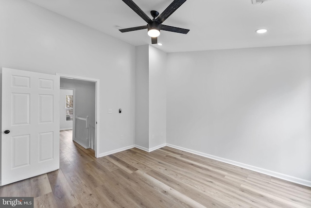 spare room featuring light wood-style floors, ceiling fan, recessed lighting, and baseboards
