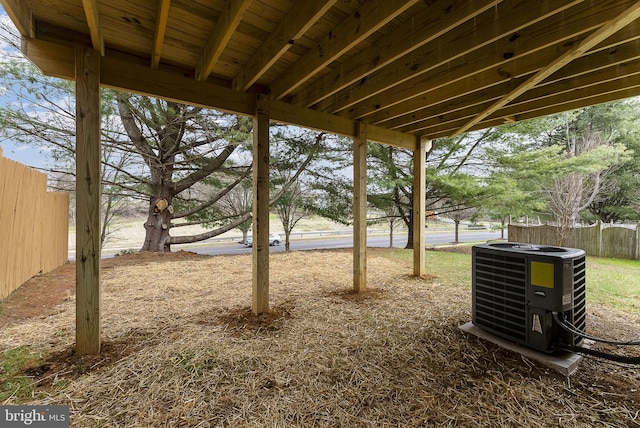 view of yard featuring central air condition unit and fence