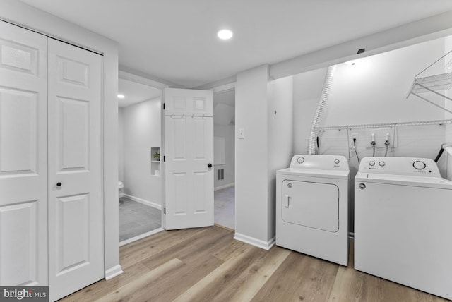 laundry area with laundry area, light wood-style floors, recessed lighting, and washer and clothes dryer