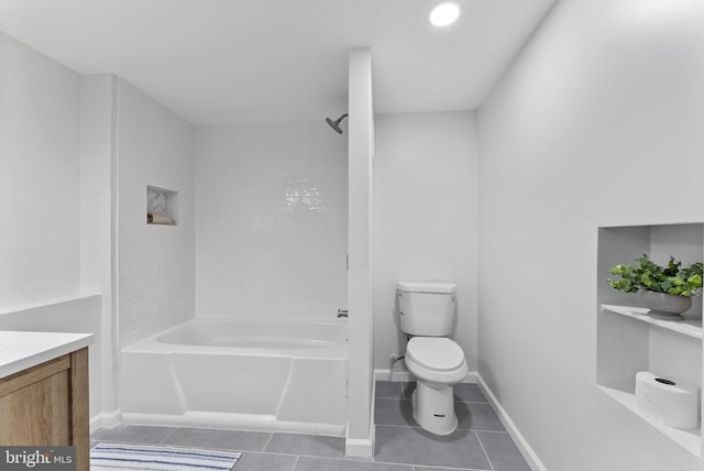 full bathroom featuring tub / shower combination, vanity, toilet, tile patterned floors, and baseboards