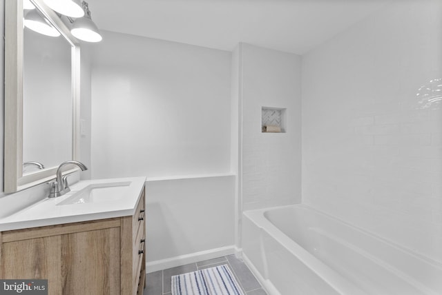 bathroom featuring tile patterned floors, vanity, baseboards, and shower / bathtub combination