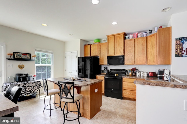 904 Emerson Ct, Clementon, NJ 08021 - kitchen with a sink, black appliances, a breakfast bar area, recessed lighting, and a kitchen island