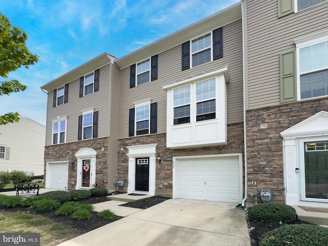 904 Emerson Ct, Clementon, NJ 08021 - townhome / multi-family property with an attached garage, stone siding, and driveway