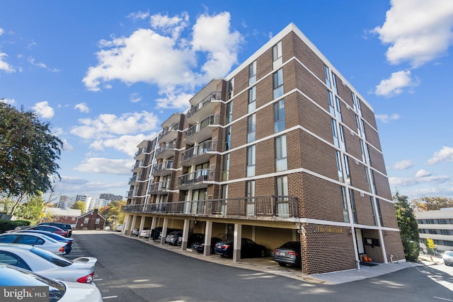 view of property with covered and uncovered parking