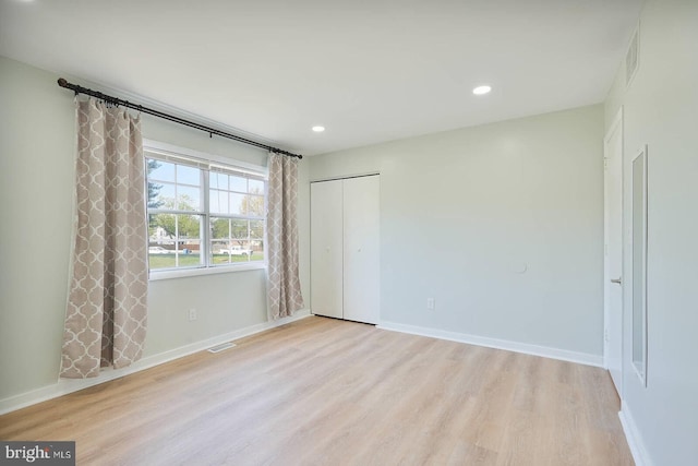 unfurnished bedroom with light wood-style floors, visible vents, and recessed lighting