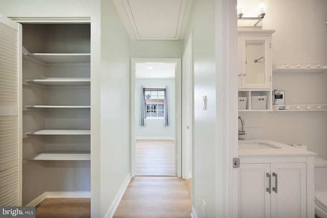 interior space featuring toilet, vanity, wood finished floors, and baseboards