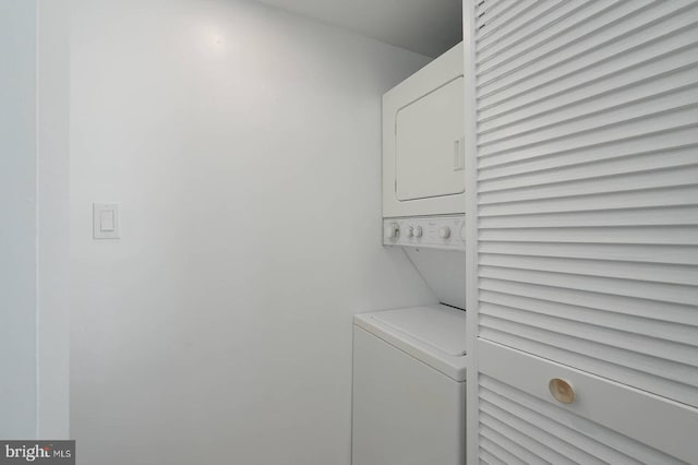 laundry area with stacked washer and dryer