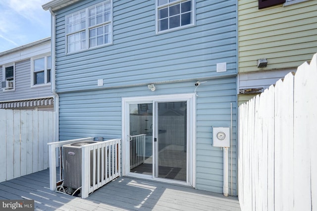wooden deck featuring fence and central AC