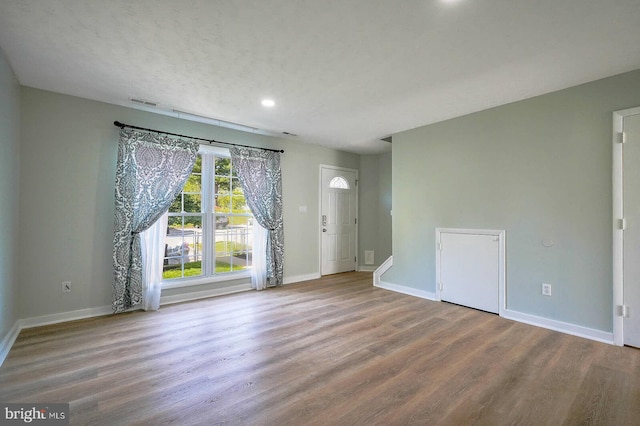 interior space with visible vents, baseboards, wood finished floors, and recessed lighting